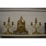 An ormolu three-piece clock garniture.