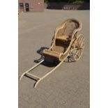 A bamboo and wicker rickshaw.