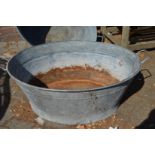 A large galvanised bath tub.