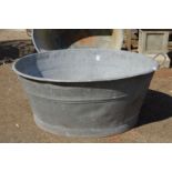 A large galvanised bath tub.