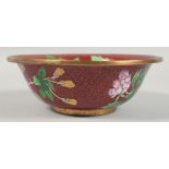 A CHINESE RED GROUND CLOISONNE BOWL decorated with flora and butterflies. 23cm diameter