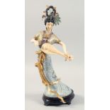 A LARGE CHINESE CLOISONNE FIGURE OF A FEMALE MUSICIAN fitted to a hardwood stand. 42cm high