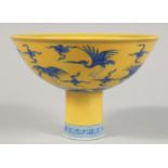 A CHINESE IMPERIAL YELLOW GROUND BLUE AND WHITE PORCELAIN STEM CUP, the exterior decorated with