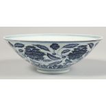 A CHINESE BLUE AND WHITE PORCELAIN BOWL, the exterior decorated with flowers and scrolling vine, the