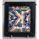 A 16TH CENTURY OTTOMAN IZNIK TILE, painted with foliate motifs and inset within an antique frame,