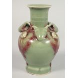 A SMALL CHINESE CELADON GLAZE VASE, with relief moulded ram's heads and three raised bosses to the