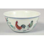 A CHINESE PORCELAIN CHICKEN CUP, the base with six-character mark, 8cm diameter.