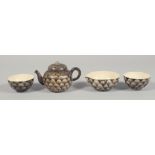 A SATSUMA FOUR-PIECE TEA SET comprising small lidded teapot, milk jug, and two teacups. Teapot