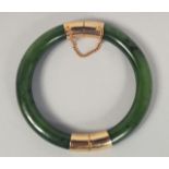 A CHINESE SPINACH JADE BANGLE, 8cm diameter.