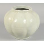 A CHINESE CELADON GLAZE OCTAGONAL LOBED JAR, the body with carved floral decoration. 20.5cm high