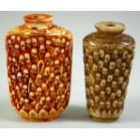 TWO CARVED BONE SCENT BOTTLES, carved with multiple faces, 6.5cm and 6cm.