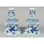 A PAIR OF CHINESE BLUE AND WHITE PORCELAIN CANDLESTICKS each decorated with phoenix and foliate