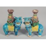 A PAIR OF CHINESE SANCAI TEMPLE LION POTTERY CANDLESTICKS, 15.5cm high