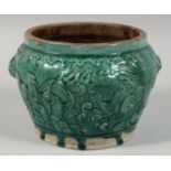 A CHINESE GREEN GLAZED POTTERY PLANTER, with raised decoration depicting a dragon and cockerel, 16.