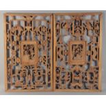 A PAIR OF LARGE CHINESE CARVED WOOD PANELS, each with a central panel of figures surrounded by