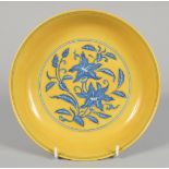 A CHINESE IMPERIAL YELLOW BLUE AND WHITE GROUND PORCELAIN DISH decorated with flora, with six-