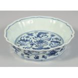 A CHINESE BLUE AND WHITE PORCELAIN PETAL FORM BOWL decorated with lotus and fish. 17.5cm diameter