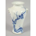 A CHINESE BLUE AND WHITE PORCELAIN TWIN-HANDLED VASE painted with birds on a branch, with characters