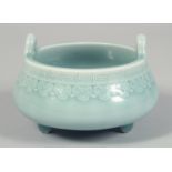 A CHINESE CELADON PORCELAIN TRIPOD CENSER, with incised greek key rim above a band of decorative