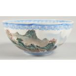A CHINESE EGGSHELL PORCELAIN RIBBED BOWL, the exterior decorated with mountainous landscape, the