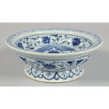 A CHINESE BLUE AND WHITE PORCELAIN BOWL, decorated with a large fish and foliate motifs, the base