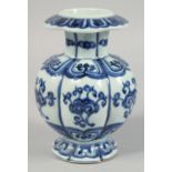 A CHINESE BLUE AND WHITE RIBBED PORCELAIN VASE, with decorative motifs to the body and six-character