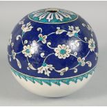 A RARE LARGE IZNIK GLAZED POTTERY HANGING BALL ORNAMENT, with a band of scrolling foliate