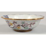 A CHINESE CLOISONNE BOWL decorated with cherry blossom and birds. 21cm diameter