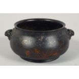 A CHINESE BRONZE TWIN HANDLE CENSER, with lion dog form handles, nine character mark to base, 12cm