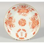 A CHINESE CORAL RED AND WHITE PORCELAIN PLATE, painted with pomegranate and bats, the base with