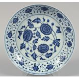 A LARGE CHINESE BLUE AND WHITE PORCELAIN DISH painted with numerous flower heads and scrolling vine.
