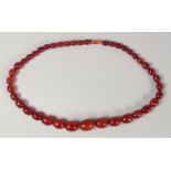 AN AMBER STYLE BEADED NECKLACE, with graduated beads.