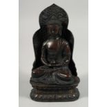 A BRONZE FIGURE OF SEATED BUDDHA, rested on a detachable base. 22cm high overall.
