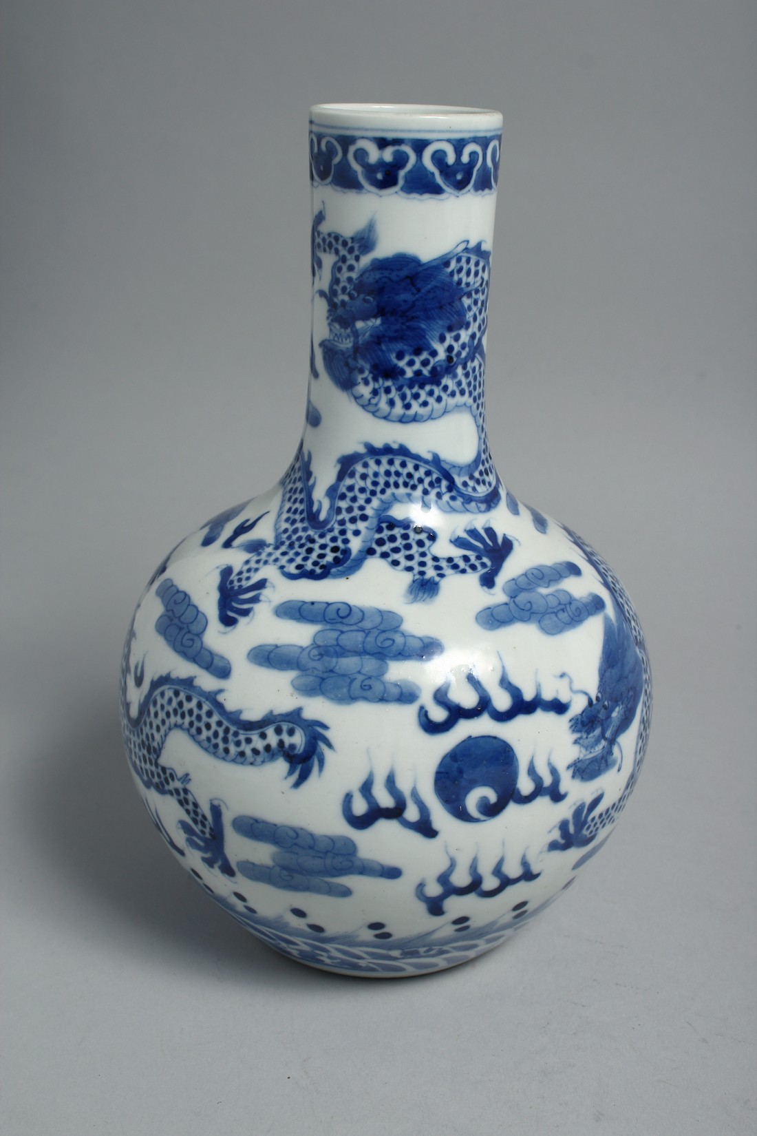 A CHINESE BLUE AND WHITE PORCELAIN BOTTLE VASE, painted with dragons and the flaming pearl of - Image 4 of 6