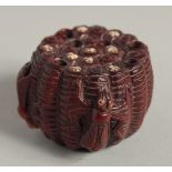 A CARVED WOOD NETSUKE with bugs 2ins.