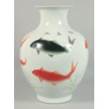 A CHINESE WHITE GROUND PORCELAIN VASE decorated with fish. 18ins high.