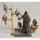 A VIENNA PAINTED BRONZE PARROT SELLER with parrots, owl, and monkey by his side. 6ins high.