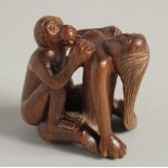 A CARVED WOOD EROTIC NETSUKE. 1.5ins.