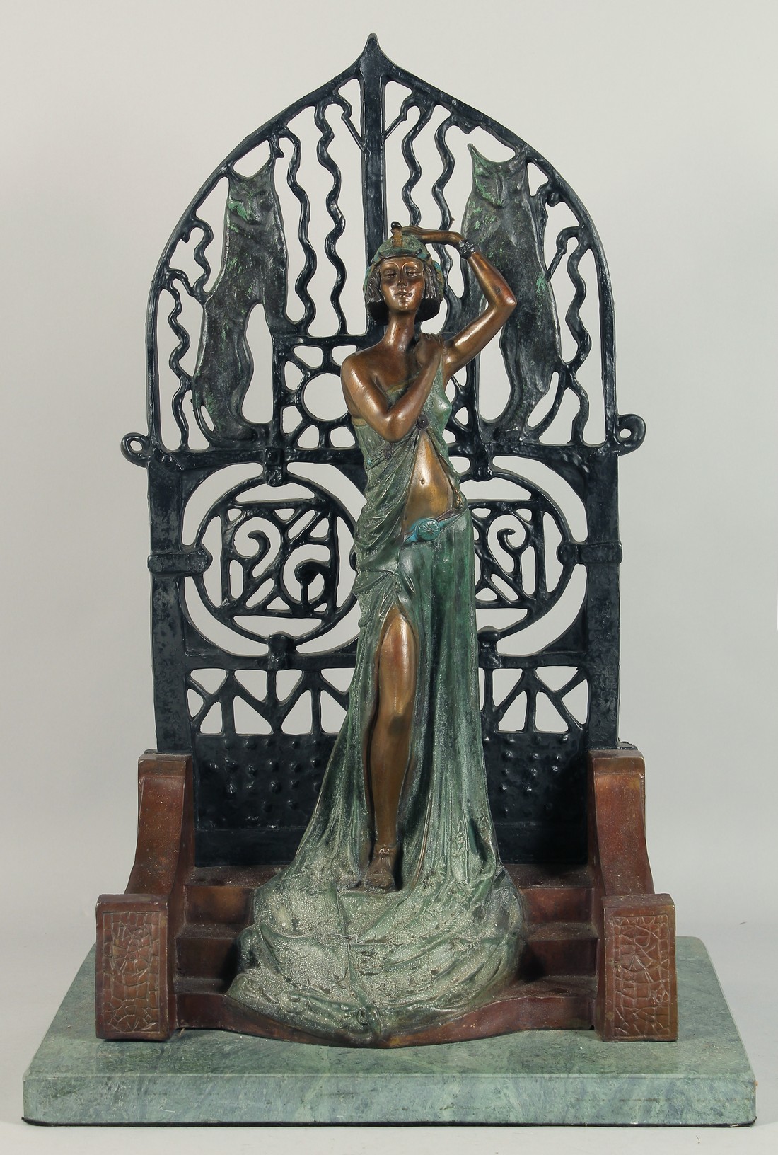 A GOOD LARGE DECO BRONZE GIRL standing by a gate on a marble base. 2ft 2ins high.