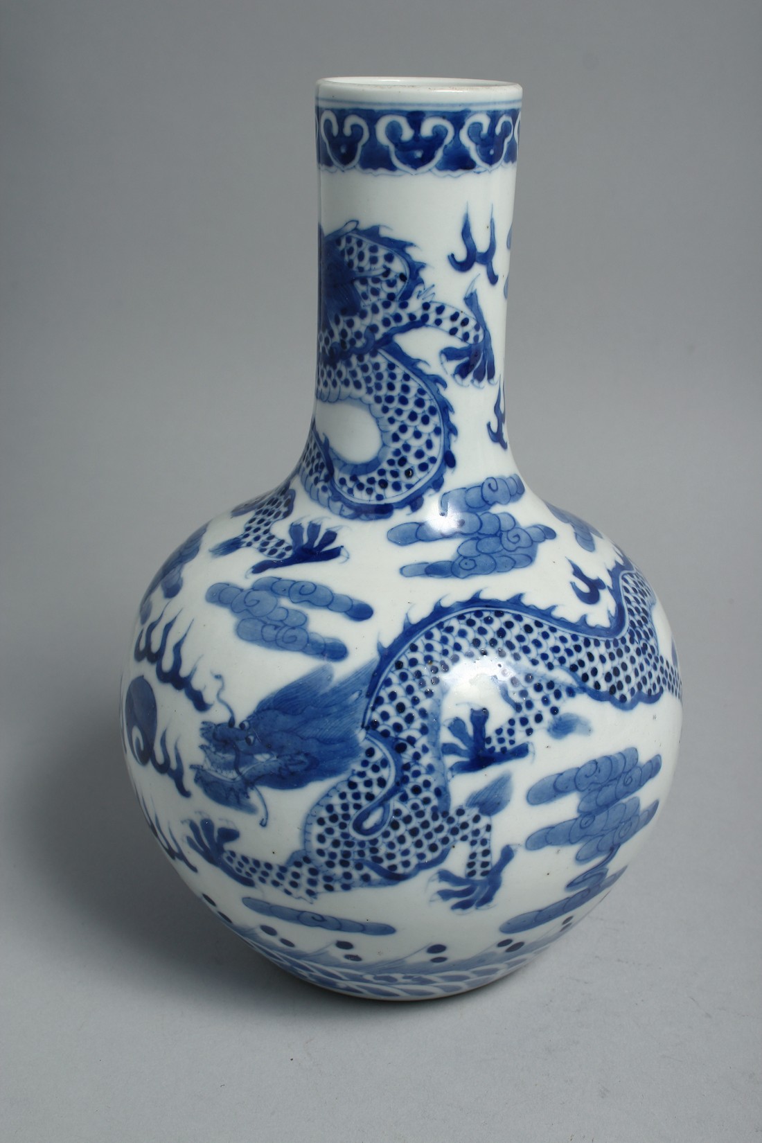 A CHINESE BLUE AND WHITE PORCELAIN BOTTLE VASE, painted with dragons and the flaming pearl of - Image 3 of 6