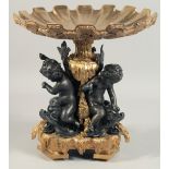 A GOOD ONYX AND BRONZE CHINESE STYLE TAZZA held by three cherubs. 13ins high.