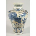 A CHINESE BLUE AND WHITE PORCELAIN VASE decorated with figures with dog of Foe handles. 13ins high.