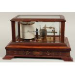 A VERY GOOD BAROGRAPH in a glass and mahogany case with spare charts and ink