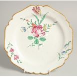 A 19TH CENTURY FRENCH PLATE painted with flowers. 9ins diameter.