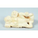 AN EROTIC CARVED BONE NETSUKE.