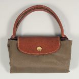 A LONGCHAMP BAG 7ins x 3.5ins with two handles.