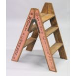 A NOVELTY PAIR PINK OF FOLDING WOODEN STEPS.