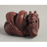 A CARVED WOOD NETSUKE, DRAGON. 2ins.