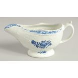 AN 18TH CENTURY LOWESTOFT MOULDED SAUCE BOAT printed with flowers, the border painted in