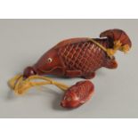 A CARVED WOOD CARP INRO with rope.